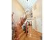 Welcoming entryway boasts an ornate staircase, chandelier, and gleaming hardwood floors with views of the living room at 2050 Lake Circle Dr, Thornton, CO 80241