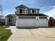 Beautiful two-story home featuring a three-car garage and painted brick accents at 2050 Lake Circle Dr, Thornton, CO 80241