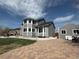 Spacious gray home with a brick paver patio and separate garage at 2050 Lake Circle Dr, Thornton, CO 80241