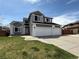 Charming two-story home with a well-manicured lawn and three-car garage at 2050 Lake Circle Dr, Thornton, CO 80241