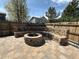 Outdoor brick firepit with built-in seating in a fenced backyard creates a cozy gathering spot at 2050 Lake Circle Dr, Thornton, CO 80241