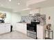 Modern kitchen with tile backsplash, stainless steel appliances, and white cabinets at 2050 Lake Circle Dr, Thornton, CO 80241