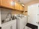 A functional laundry room complete with modern washer and dryer, sink, and cabinetry at 2050 Lake Circle Dr, Thornton, CO 80241