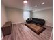 Inviting living room features modern gray sofa, stylish area rug and wood-look floors at 2050 Lake Circle Dr, Thornton, CO 80241
