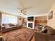 Inviting living room featuring a cozy fireplace, plush couches, and large windows for natural light at 2050 Lake Circle Dr, Thornton, CO 80241