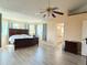 Spacious bedroom has a tray ceiling, a ceiling fan, and big windows with blue curtains at 2050 Lake Circle Dr, Thornton, CO 80241