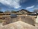 Stone outdoor kitchen featuring a built-in grill, stainless steel cabinets, and ample counter space at 2050 Lake Circle Dr, Thornton, CO 80241