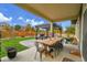 The backyard patio has outdoor dining with an outdoor kitchen and shade at 16060 Fairway, Commerce City, CO 80022