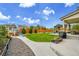 The backyard features a grass lawn, patio, outdoor kitchen, raised garden beds, and a playset at 16060 Fairway, Commerce City, CO 80022