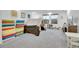Spacious basement with gray carpet, play tent, and colorful playmats at 16060 Fairway, Commerce City, CO 80022