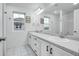 Bright bathroom featuring double sinks, decorative wall hangings and a large mirror at 16060 Fairway, Commerce City, CO 80022