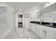 Bathroom featuring double sinks with black countertops and a large mirror at 16060 Fairway, Commerce City, CO 80022