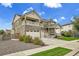 Beautiful two-story home with stone accents, a spacious balcony, and a well-manicured lawn at 16060 Fairway, Commerce City, CO 80022