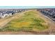Aerial view of a community golf course surrounded by residential homes at 16060 Fairway, Commerce City, CO 80022