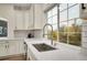 Bright kitchen features a large sink, modern fixtures, and a window offering a view of the outdoors at 16060 Fairway, Commerce City, CO 80022