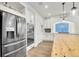 Kitchen showcasing stainless steel appliances, a large island, modern cabinets, and an eat-in area at 16060 Fairway, Commerce City, CO 80022