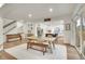 Bright open-concept living room boasts wood floors, a dining area, and seamless flow to the modern kitchen at 16060 Fairway, Commerce City, CO 80022