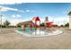Community pool and splashpad featuring a play structure and water tower with lounge seating at 16060 Fairway, Commerce City, CO 80022