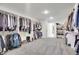 Large walk-in closet with custom shelving, multiple rods, and plenty of room for clothing and shoes at 16060 Fairway, Commerce City, CO 80022