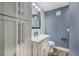 Well-lit bathroom with vanity, storage cabinets, and modern fixtures at 6360 W 1St Ave, Lakewood, CO 80226