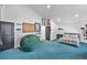 Large bedroom with high ceilings, comfy beanbag, and vibrant blue carpet at 6360 W 1St Ave, Lakewood, CO 80226