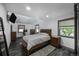 Cozy bedroom with hardwood floors, many windows, and relaxing natural light at 6360 W 1St Ave, Lakewood, CO 80226
