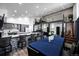 Open-concept dining room adjacent to kitchen with a large table and modern seating, ideal for entertaining at 6360 W 1St Ave, Lakewood, CO 80226