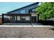 Contemporary home with a modern design, unique roofline, and inviting covered porch in a landscaped setting at 6360 W 1St Ave, Lakewood, CO 80226