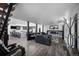 Open living space with a modern fireplace, kitchen access, hardwood floors, and great natural light at 6360 W 1St Ave, Lakewood, CO 80226