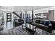 Spacious open-concept living room with hardwood floors, modern decor, and staircase to the upper level at 6360 W 1St Ave, Lakewood, CO 80226