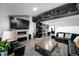 Open living space featuring a fireplace, modern design elements, and staircase to the upper level at 6360 W 1St Ave, Lakewood, CO 80226