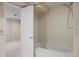 Bathroom featuring bathtub, shower, and cream-colored tile at 4580 S Huron St, Englewood, CO 80110