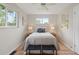 Bedroom featuring a comfortable bed, hardwood floors, and windows for plenty of natural light at 4580 S Huron St, Englewood, CO 80110