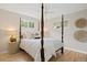 Inviting bedroom with hardwood floors, a four-poster bed, and decorative wall art at 4580 S Huron St, Englewood, CO 80110