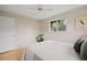 Well-lit bedroom with hardwood floors, a large window, and neutral decor at 4580 S Huron St, Englewood, CO 80110