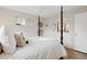 Comfortable bedroom with a four-poster bed, hardwood floors, and natural light from the window at 4580 S Huron St, Englewood, CO 80110