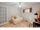 Bright bedroom with a ceiling fan, natural light, wooden floor, a loveseat and desk and chair at 4580 S Huron St, Englewood, CO 80110