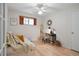 Bright bedroom with a ceiling fan, natural light, wooden floor, and a desk and chair at 4580 S Huron St, Englewood, CO 80110