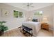Cozy bedroom with hardwood floors, a ceiling fan, and bright windows with natural light at 4580 S Huron St, Englewood, CO 80110
