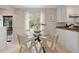 Light and bright dining room with a glass table, lots of light, white walls and tile floors at 4580 S Huron St, Englewood, CO 80110