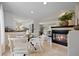 Modern home featuring dining area with fireplace and view of the living room and updated kitchen at 4580 S Huron St, Englewood, CO 80110