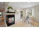 Cozy dining room area featuring a fireplace, tile floors, bright lighting and a round table at 4580 S Huron St, Englewood, CO 80110