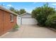 Long driveway leading to a two-car garage, adjacent to a brick home, offering ample parking space at 4580 S Huron St, Englewood, CO 80110