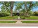Charming home with mature trees, well-manicured lawn, and appealing landscaping enhances curb appeal at 4580 S Huron St, Englewood, CO 80110