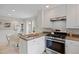 Updated kitchen features stainless steel appliances and white cabinets near a cozy dining area at 4580 S Huron St, Englewood, CO 80110