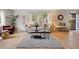Bright living room with large windows, hardwood floors, stylish furniture, and cozy rug at 4580 S Huron St, Englewood, CO 80110