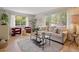 Sunlit living room boasts hardwood floors, neutral decor, large windows, and comfortable seating at 4580 S Huron St, Englewood, CO 80110