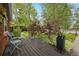 Cozy front porch featuring wood decking, light blue seating, and beautiful landscaping for added curb appeal at 4580 S Huron St, Englewood, CO 80110