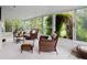Relaxing sun room filled with natural light, comfortable wicker seating, and views of lush greenery at 4580 S Huron St, Englewood, CO 80110