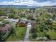 Aerial view of the property showcasing the landscaped yard, driveway, and the surrounding neighborhood at 1415 Isabell St, Golden, CO 80401